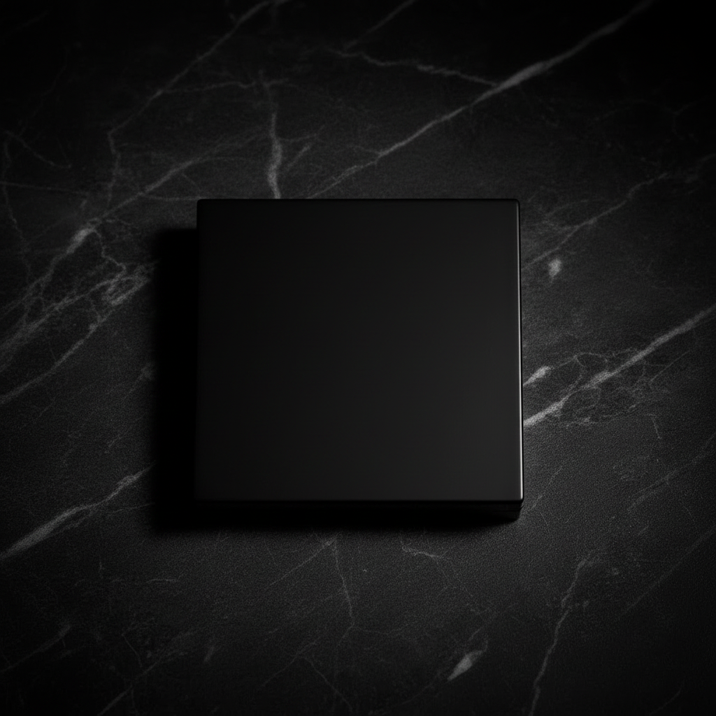 Matte black quad palette closed top-down flat lay on dark marble