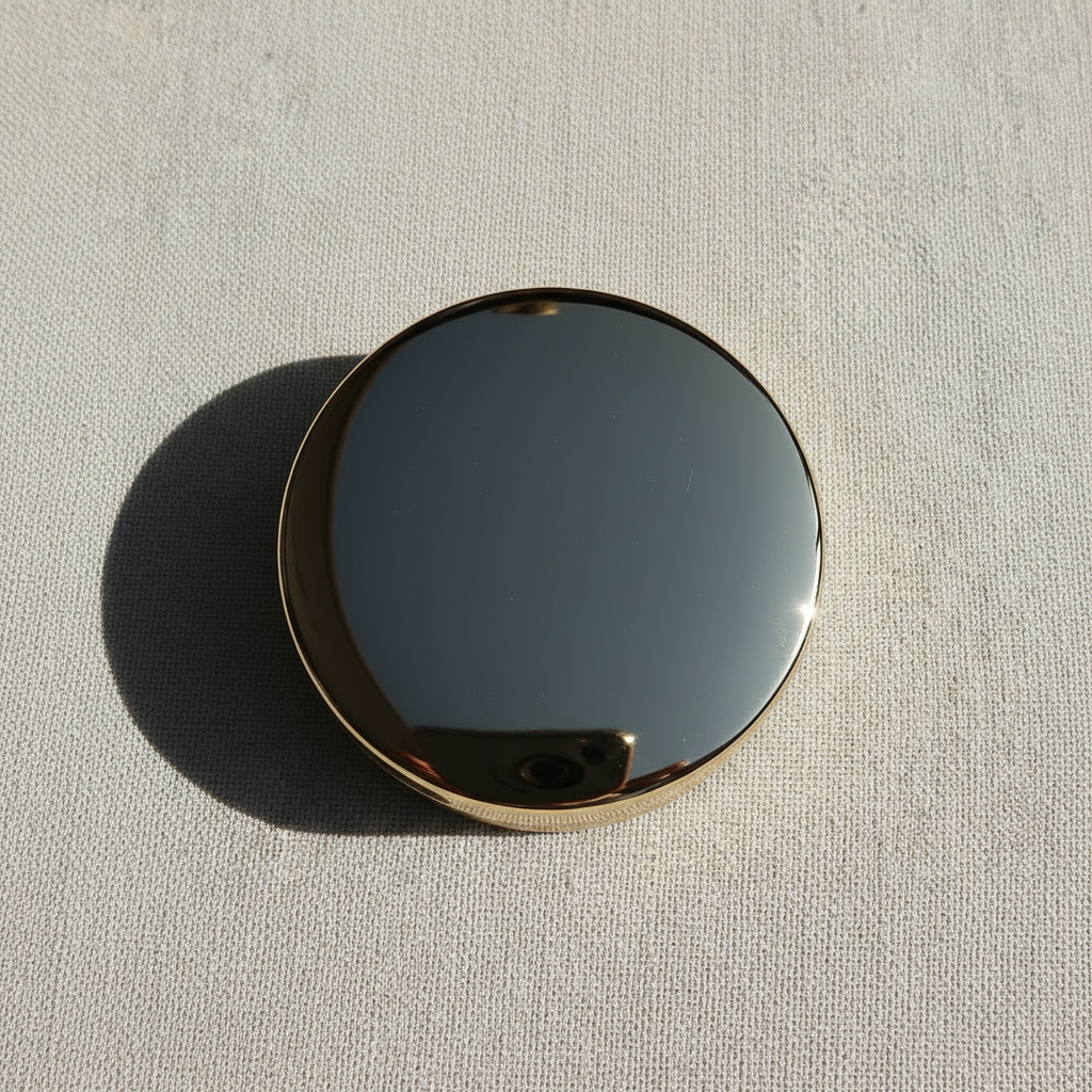 Gold compact closed top-down flat lay view
