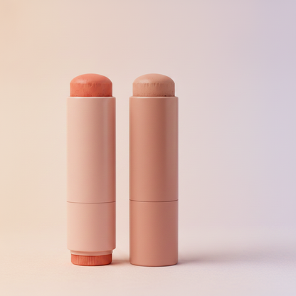 Close-up side angle of coral orange blush stick showing sponge tip and twist mechanism